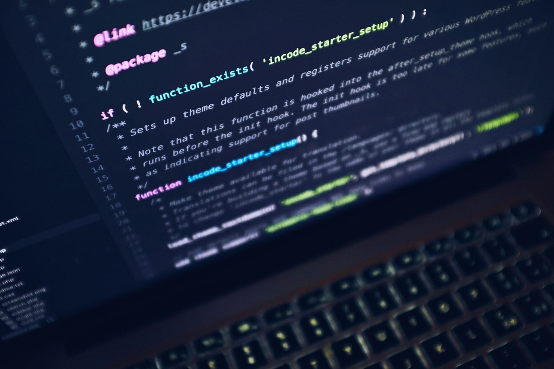Source code on a laptop screen in a dark room