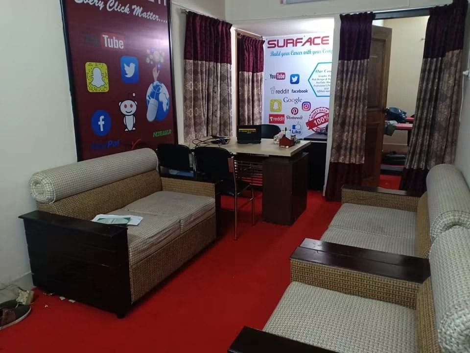 Reception room of the original Surface IT office, with a Surface IT Institute banner listing its courses.